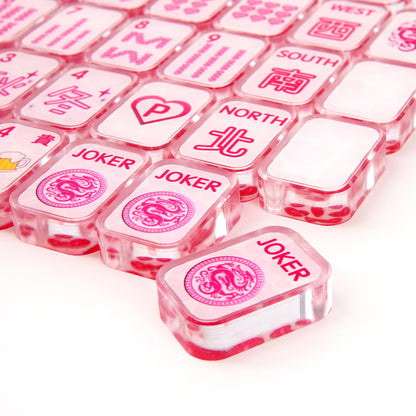 Close‑up of acrylic mahjong tile showing polished rounded edges and vibrant pink detailing
