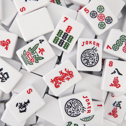 Close‑up of acrylic mahjong tile showing polished rounded edges and engraved artwork
