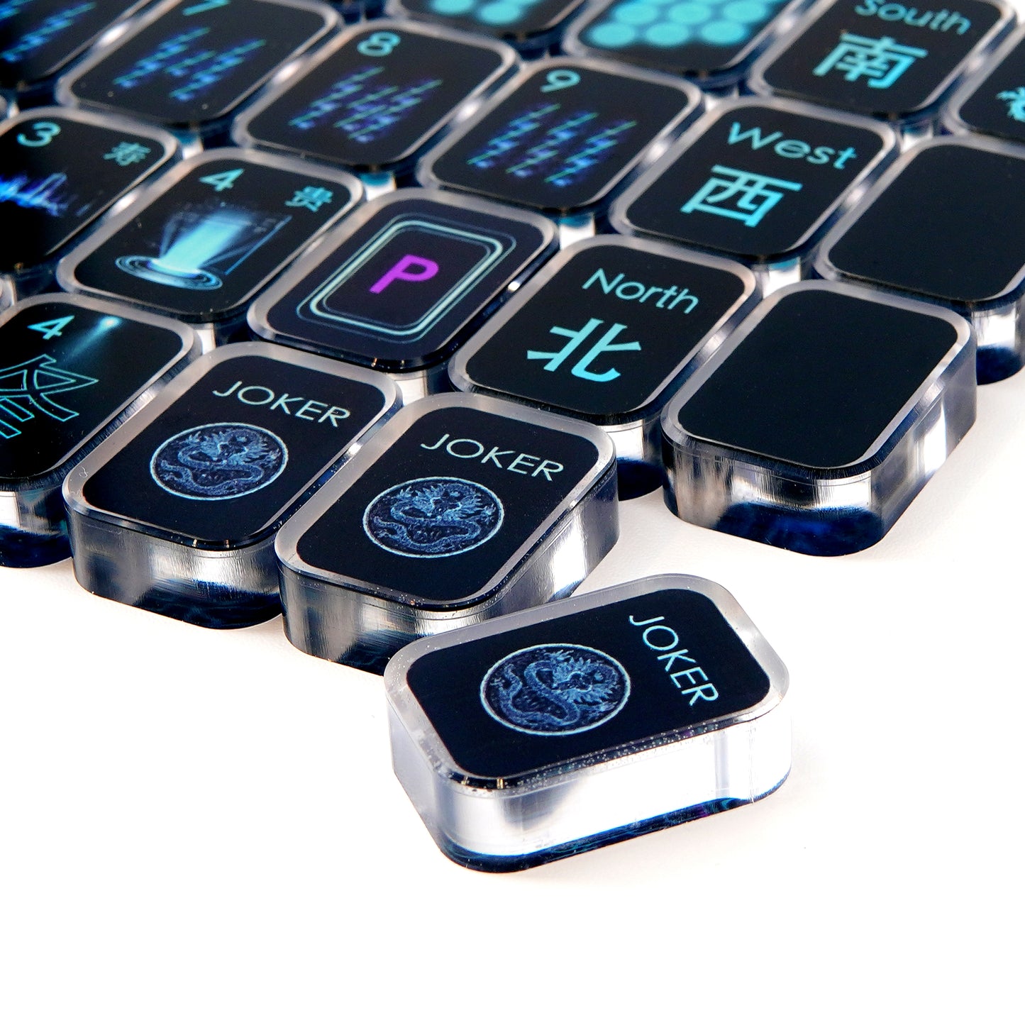 close view of black cyber transparent acrylic mahjong tiles showing symbols and edges