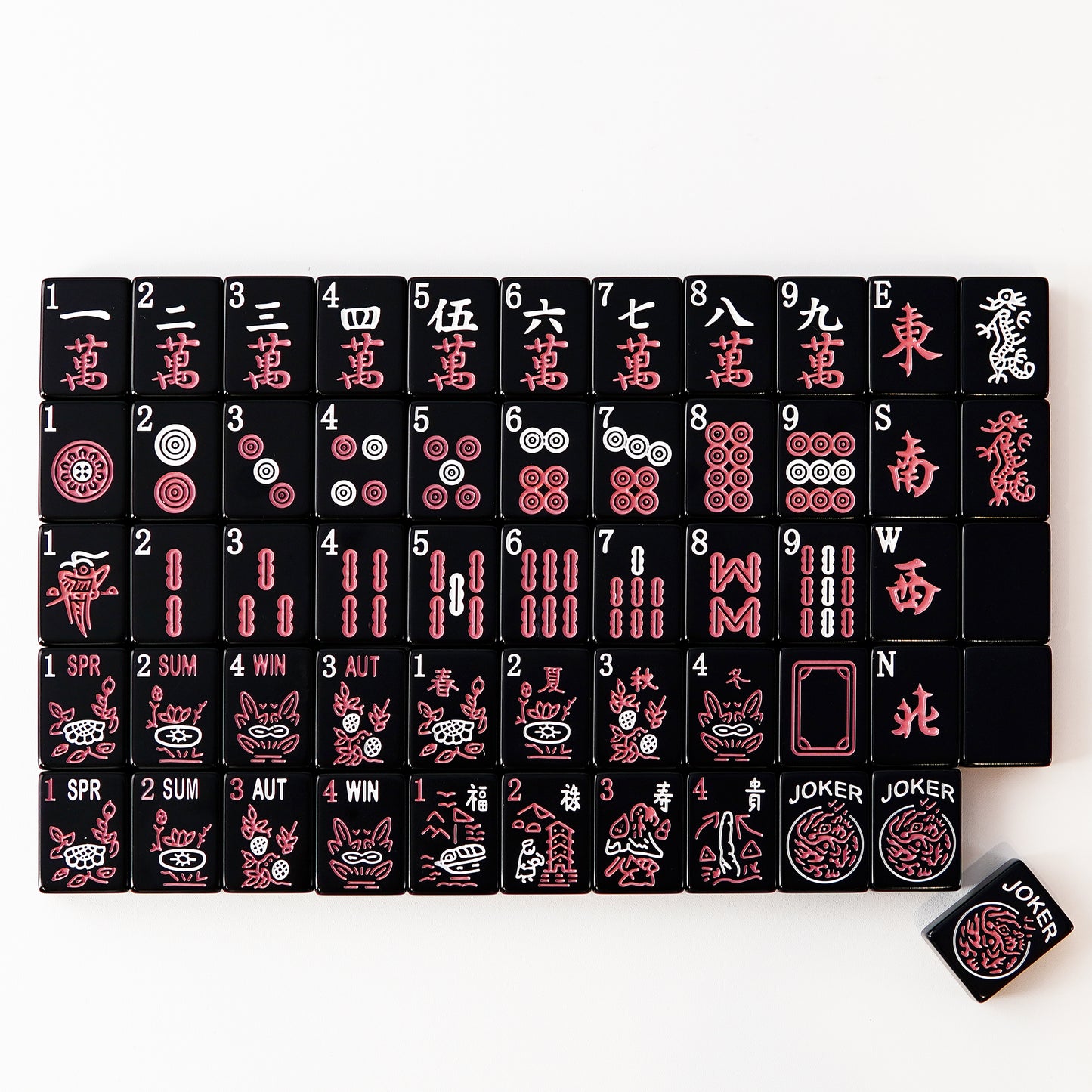 full set of black mahjong tiles neatly arranged in rows with clear traditional symbols