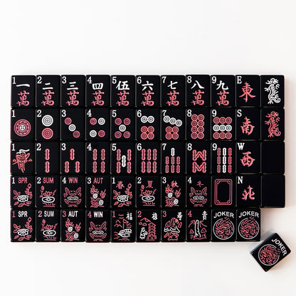 full set of black mahjong tiles neatly arranged in rows with clear traditional symbols