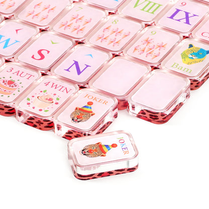 Close-up of designer pink mahjong tiles with leopard print backs and playful artwork