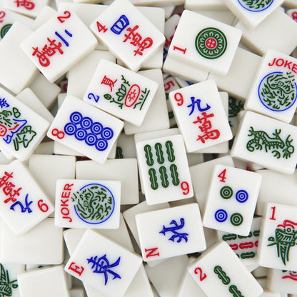 white mahjong tiles with ink painting style symbols scattered in a flat lay arrangement