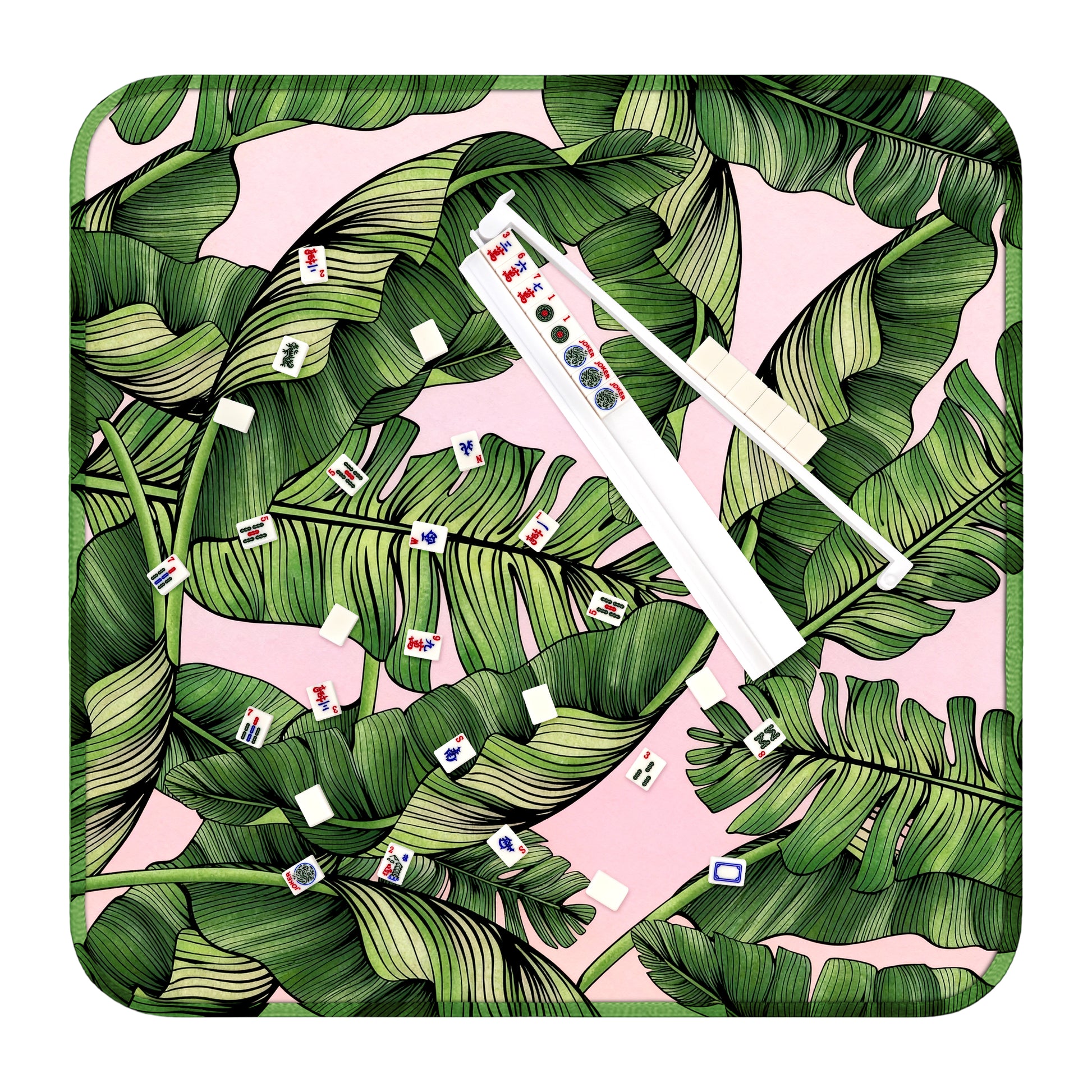 Mahjong play mat with tropical palm leaf design, tiles, and white acrylic rack for American Mahjong