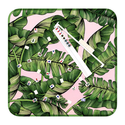 Mahjong play mat with tropical palm leaf design, tiles, and white acrylic rack for American Mahjong