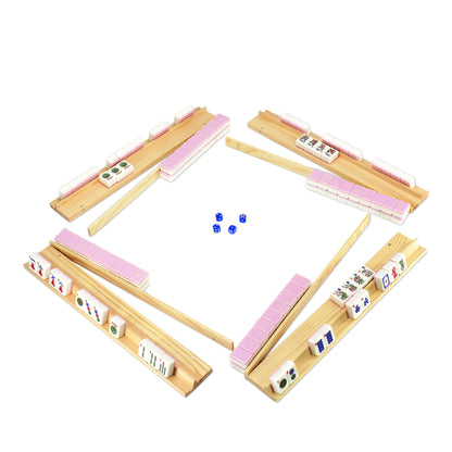 Four player layout of pink mahjong set with wooden racks and dice