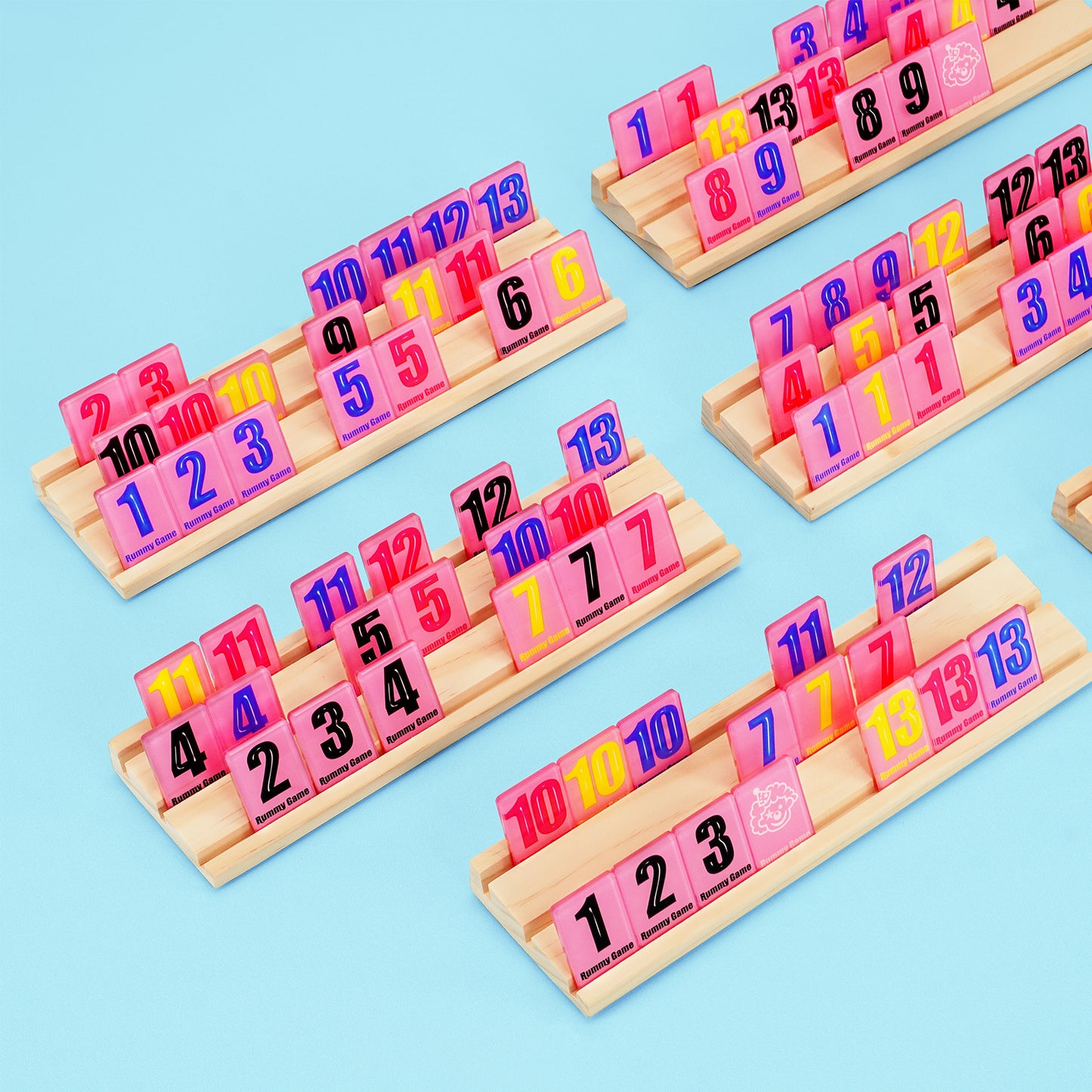 Close up of wooden racks holding colorful numbered tiles for rummy game