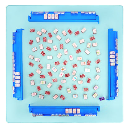 Top view of sky blue acrylic mahjong rack and pusher set arranged on game table with tiles